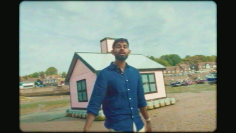 Shane by the pink beach hut at Folkestone, in the film-frame treatment — FaceTime music video